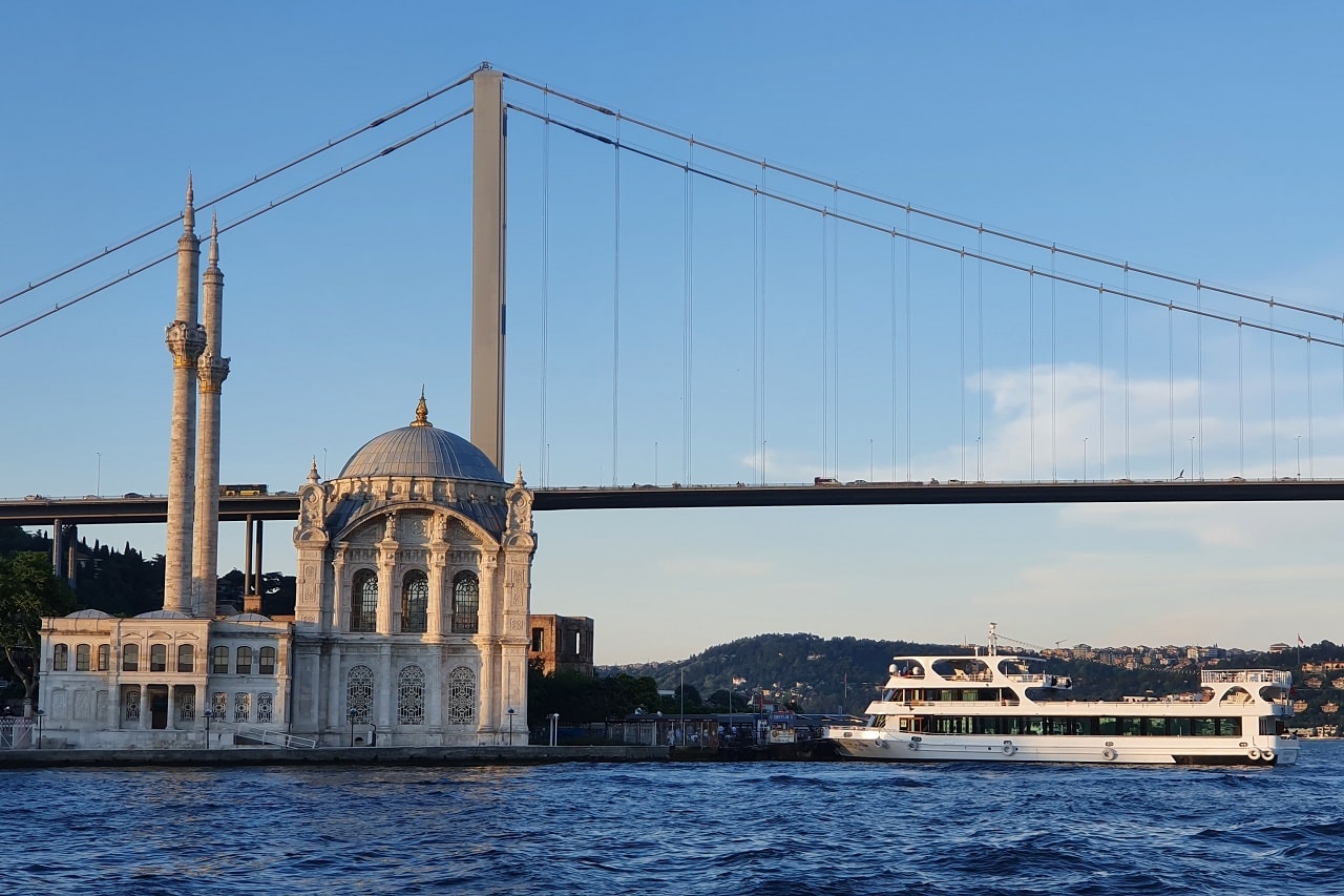 Guided tour boat cruising on the Bosphorus with a view of the Ortakoy Mosque