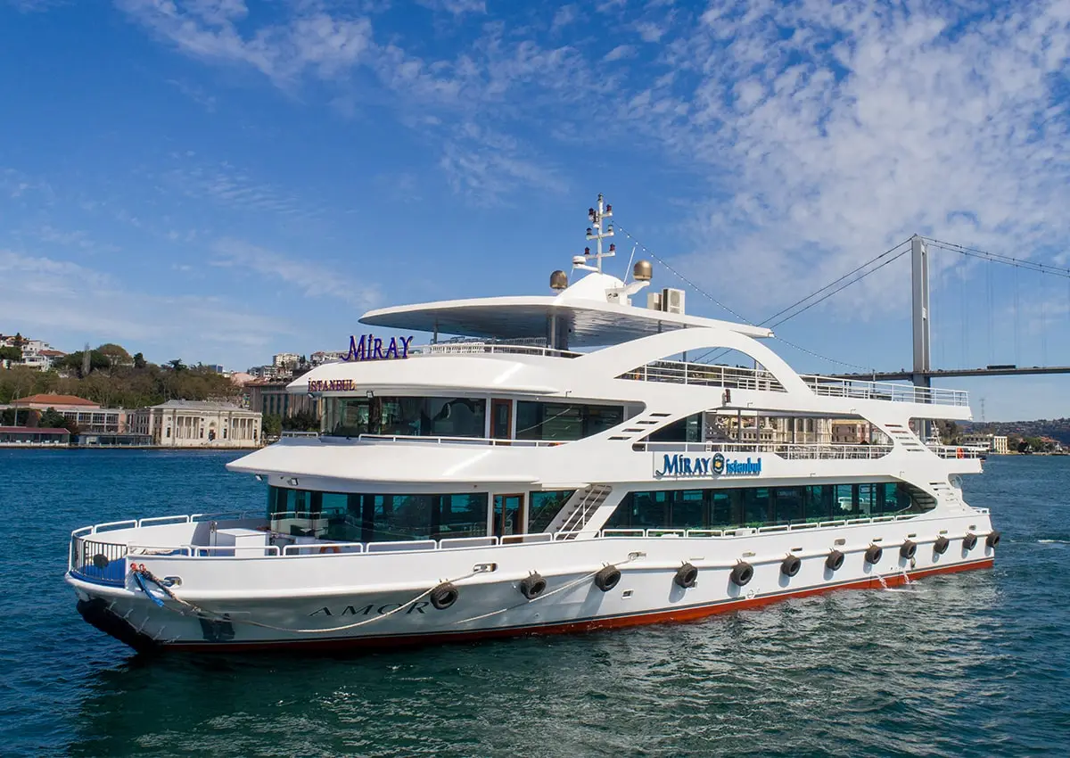 Tavern cruise ship  on Bosphorus sailing near Istanbul with a bridge in the background on a sunny day