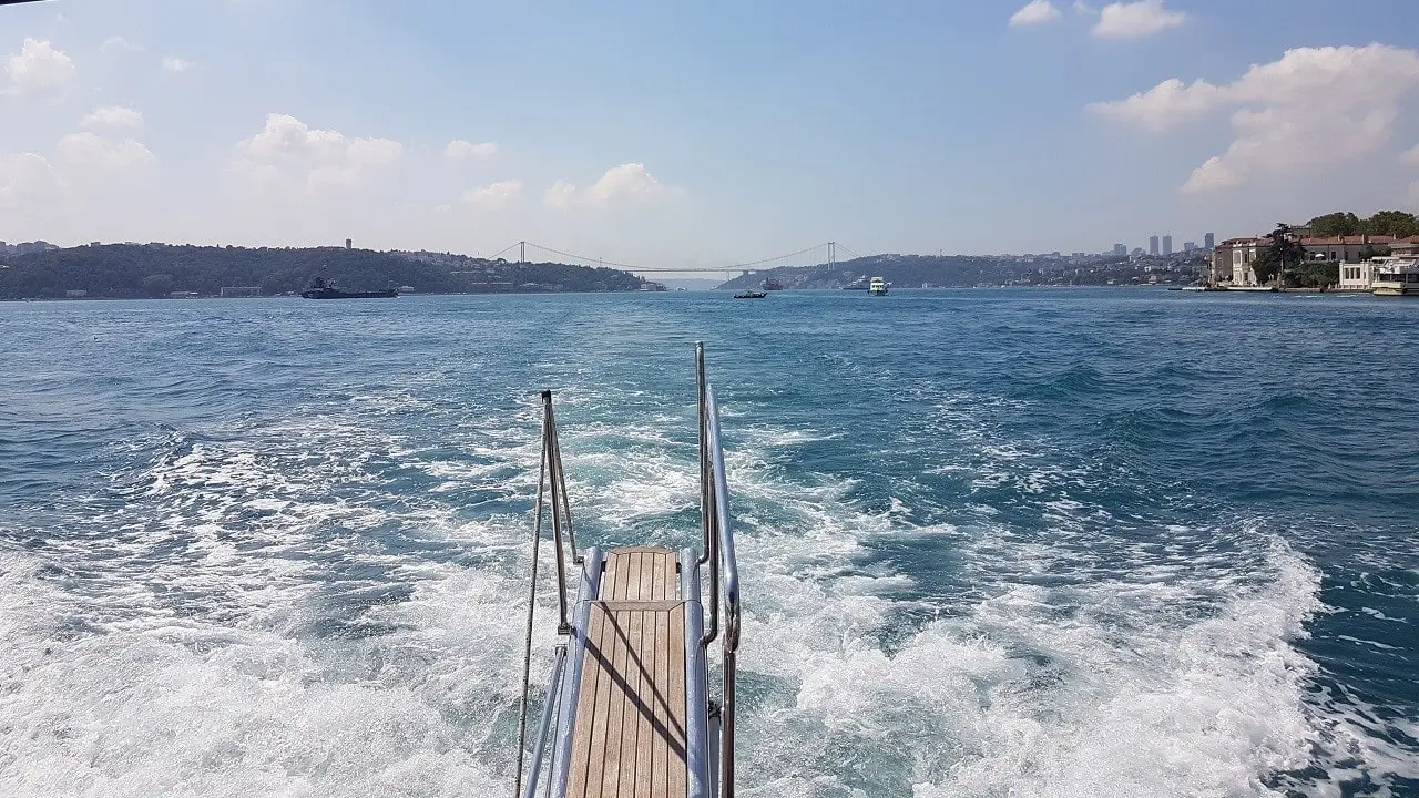 Istanbul Bosphorus Bridge and view from the front of a luxury yacht