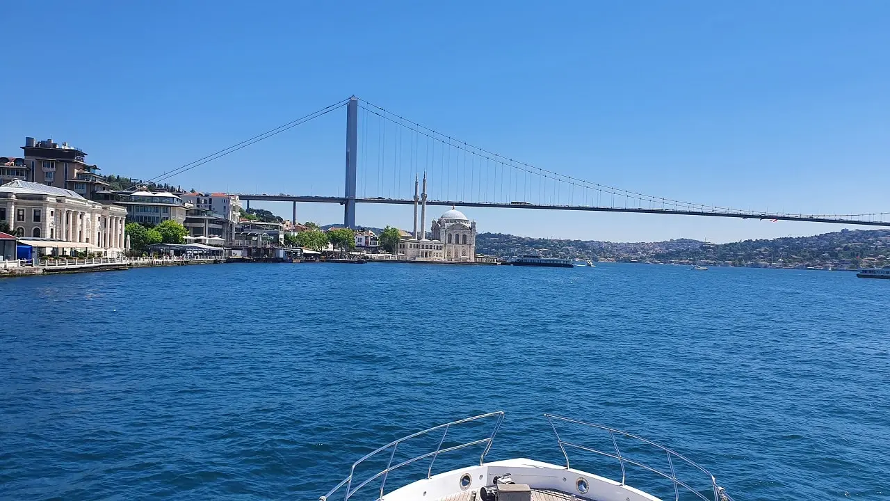 Istanbul Bosphorus Bridge and view from the front of a luxury yacht