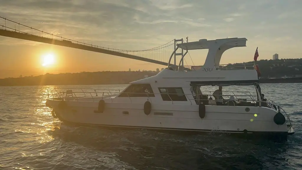 A luxury yacht cruising in the Bosphorus during the sunset