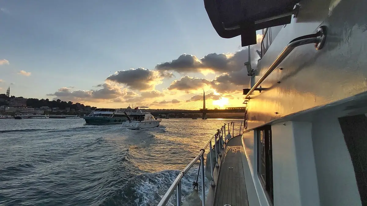 the view of the Golden Horn while the sun is setting from a luxury yacht in the Bosphorus